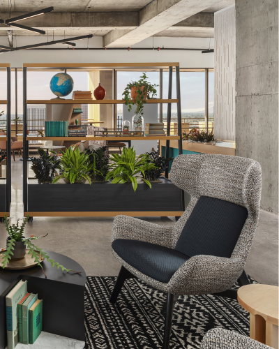 Stylish office lounge with textured armchair and plant decor by SunBest Builders.